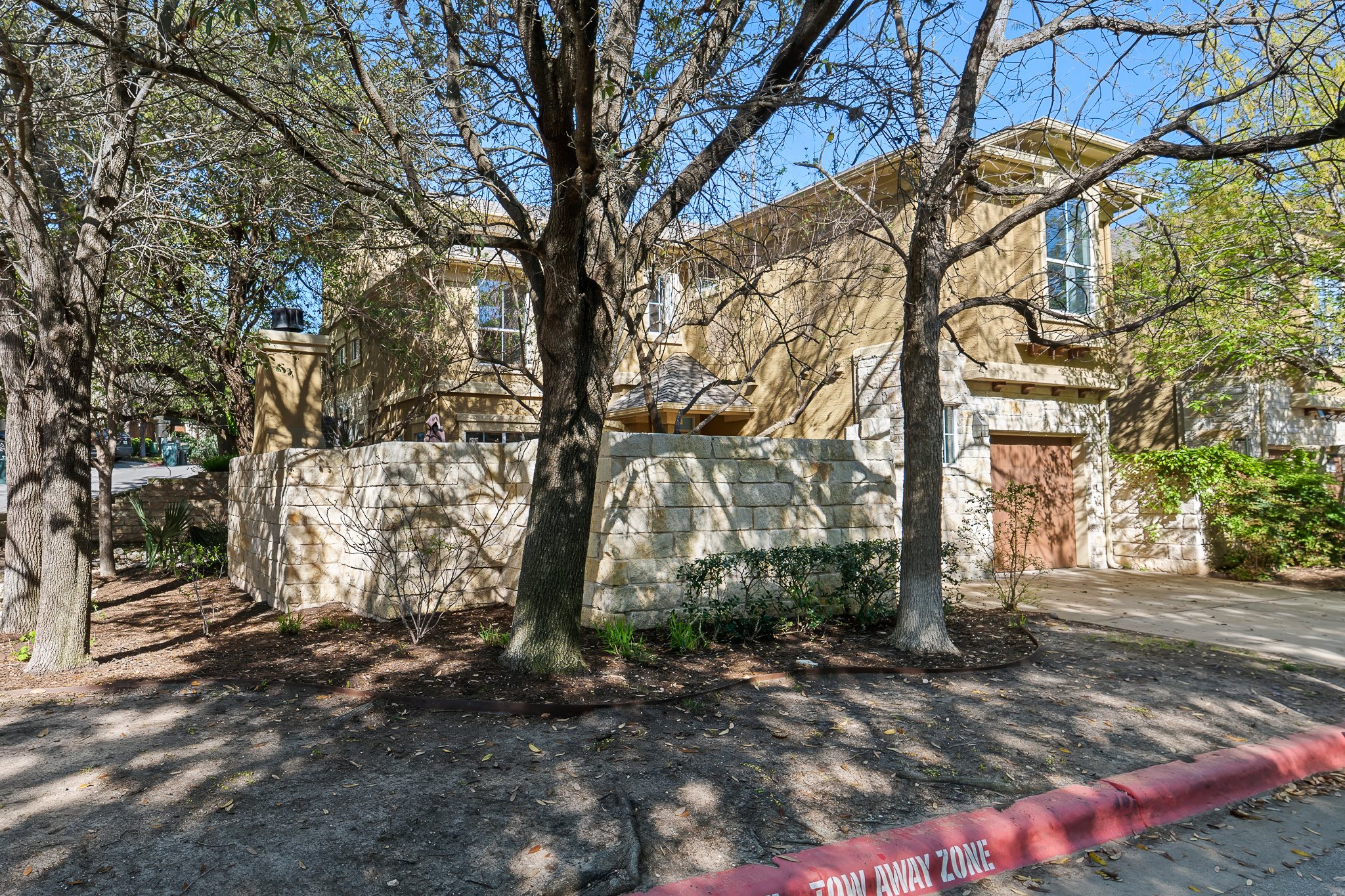 3406 Menchaca Road, Unit 28 Austin, TX 78704 - Photo 36 of 40 View of side of property with a garage and driveway