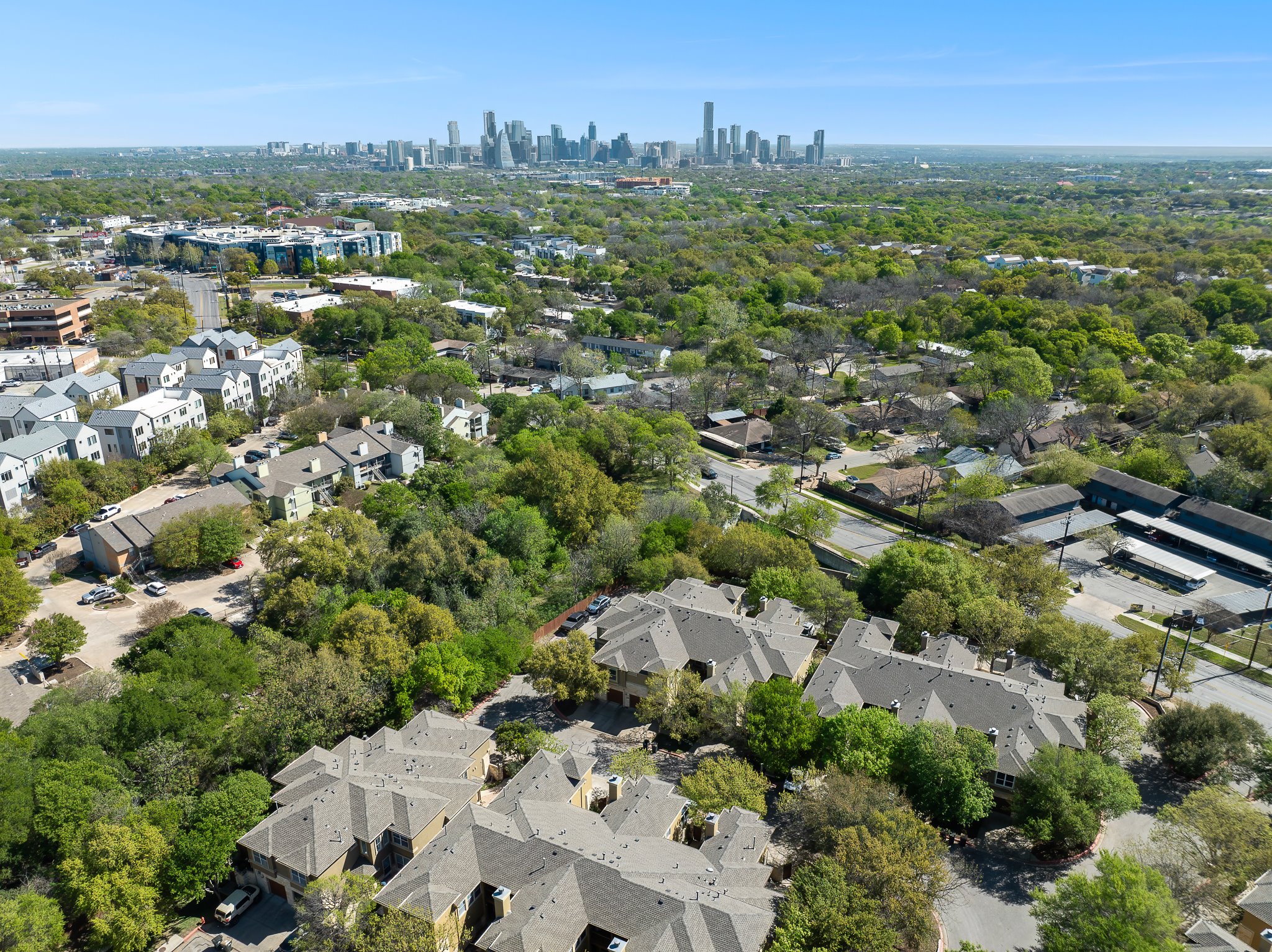 3406 Menchaca Road, Unit 28 Austin, TX 78704 - Photo 38 of 40 Aerial view of property's location with city skyline and nearby suburban area