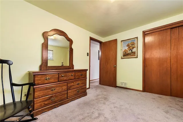 a room with a bed and a mirror