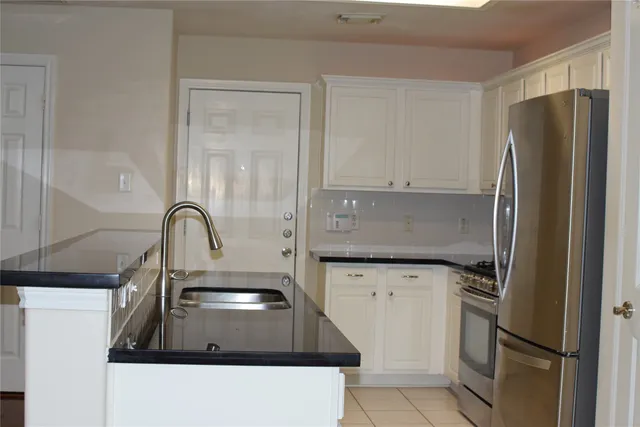 a kitchen with a refrigerator and a sink