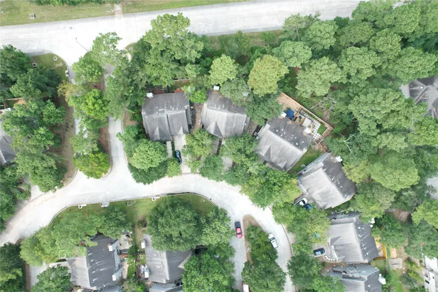 an aerial view of a house with a yard and outdoor seating