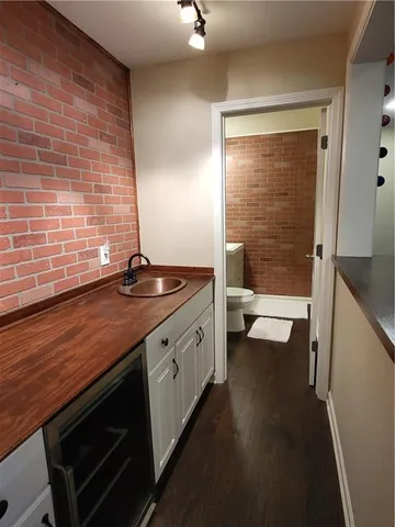 a bathroom with a granite countertop sink a toilet and shower