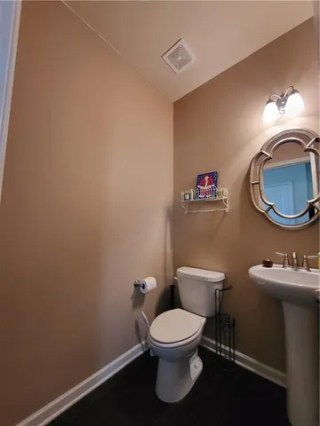 a white toilet sitting next to a bathroom sink