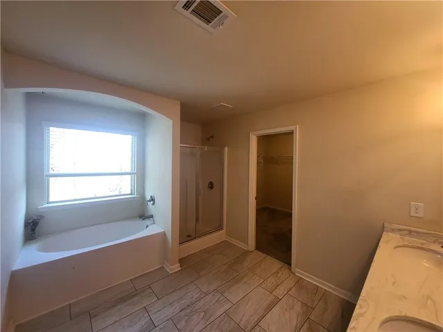 a bathroom with a tub and shower