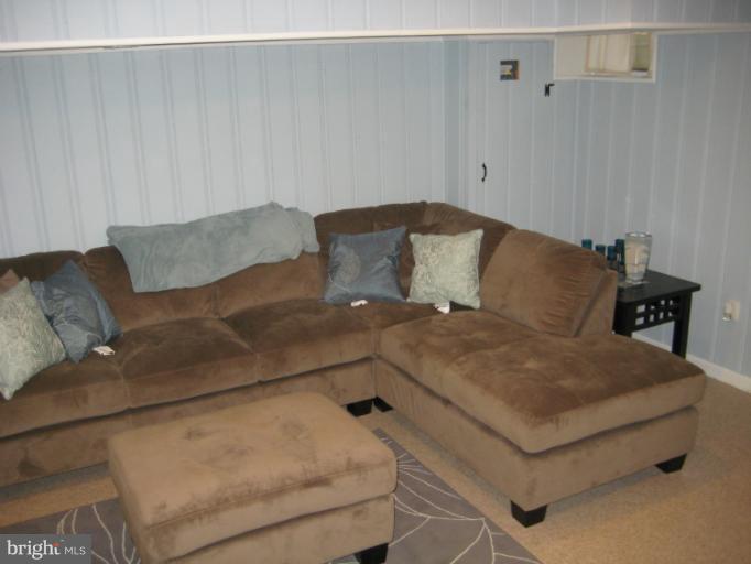 426 Stemmers Run Road Baltimore, MD 21221 - Photo 2 of 21 a living room with a couch and a couch