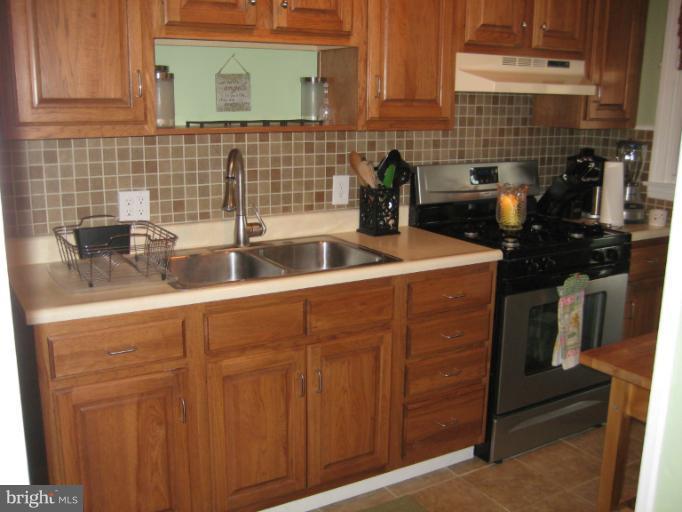 426 Stemmers Run Road Baltimore, MD 21221 - Photo 15 of 21 a kitchen with a sink and cabinets
