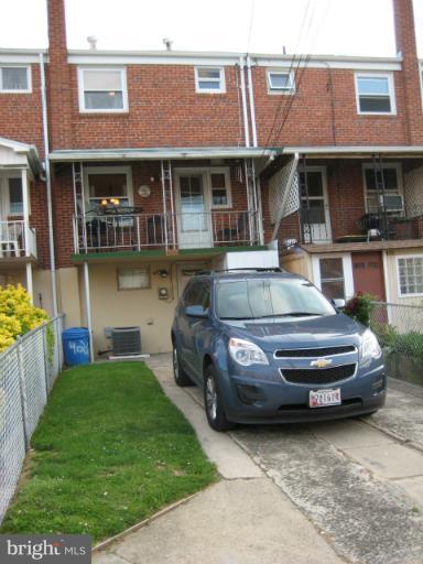 426 Stemmers Run Road Baltimore, MD 21221 - Photo 19 of 21 a front view of a house with a garden