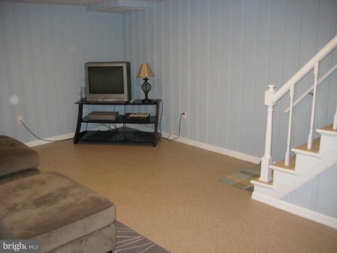 426 Stemmers Run Road Baltimore, MD 21221 - Photo 6 of 21 a living room with furniture and a flat screen tv