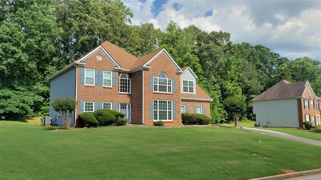 a front view of a house with a garden