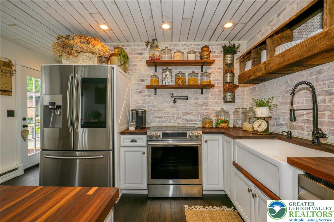 68 Mitchell Avenue Nazareth, PA 18064 - Photo 4 of 45 a kitchen with stainless steel appliances granite countertop a stove and a refrigerator