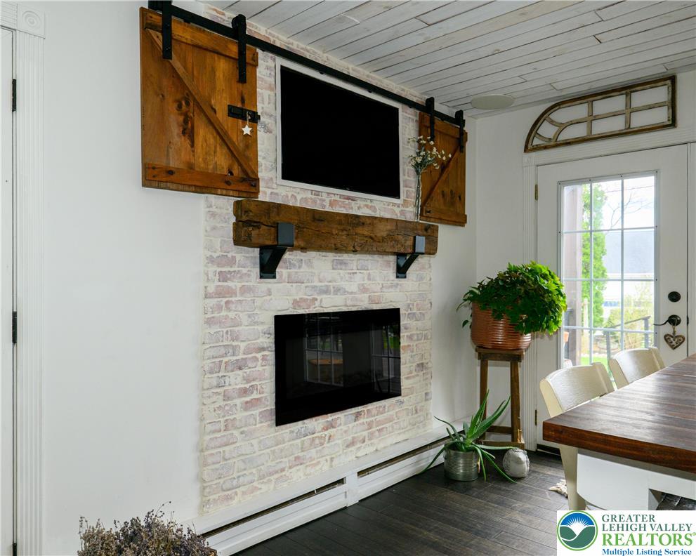 68 Mitchell Avenue Nazareth, PA 18064 - Photo 5 of 45 a living room with furniture a fireplace and a flat screen tv