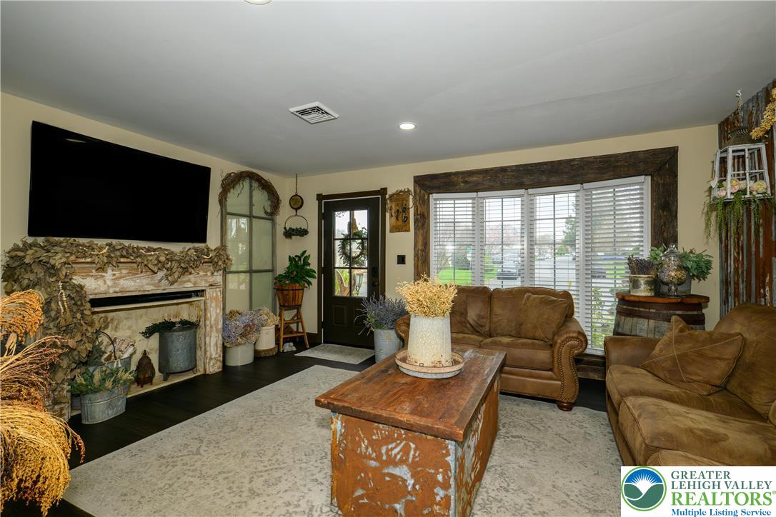68 Mitchell Avenue Nazareth, PA 18064 - Photo 7 of 45 a living room with furniture a flat screen tv and a fireplace