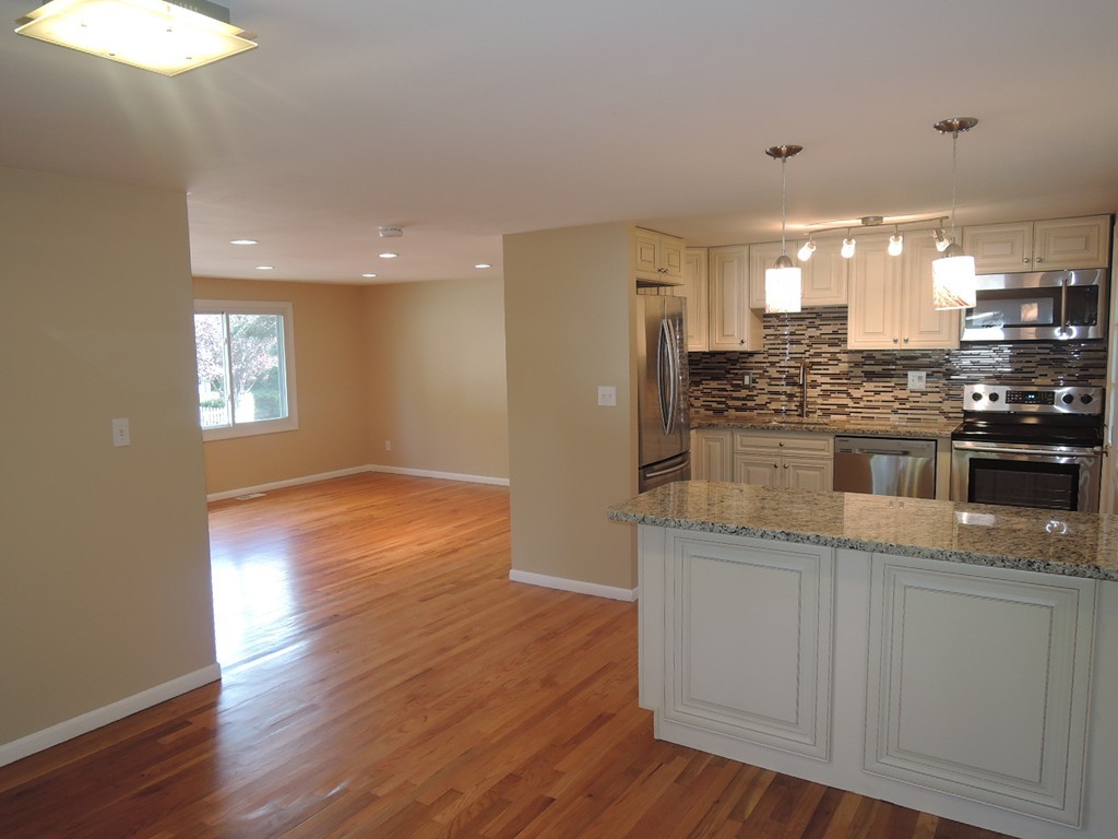 19 Dietz Road Boston, MA 02136 - Photo 1 of 15 a kitchen with kitchen island granite countertop wooden floors and wide window