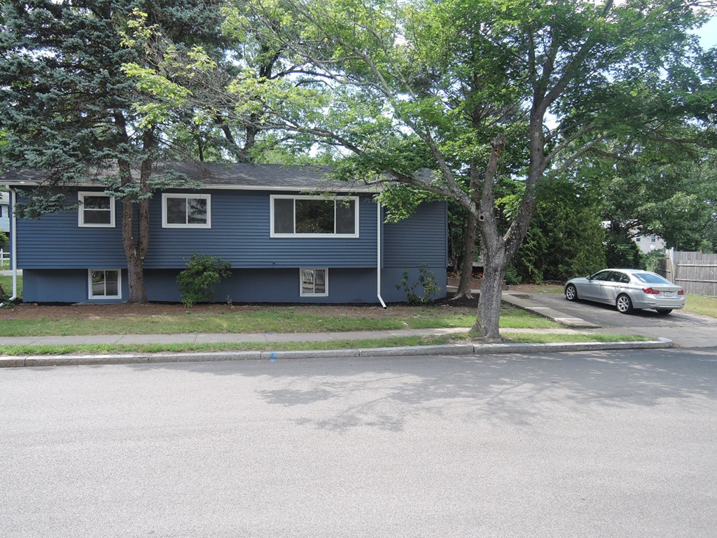 19 Dietz Road Boston, MA 02136 - Photo 13 of 15 a front view of a house with a garden and trees