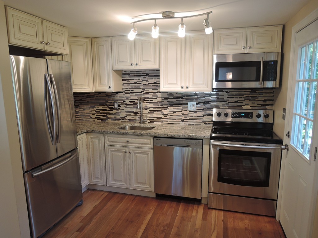 19 Dietz Road Boston, MA 02136 - Photo 2 of 15 a kitchen with stainless steel appliances a refrigerator stove and microwave