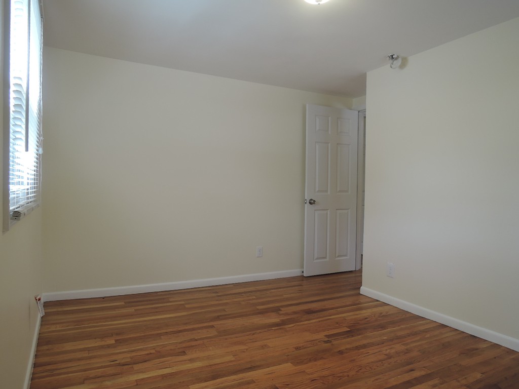 19 Dietz Road Boston, MA 02136 - Photo 6 of 15 a view of an empty room with wooden floor and a window