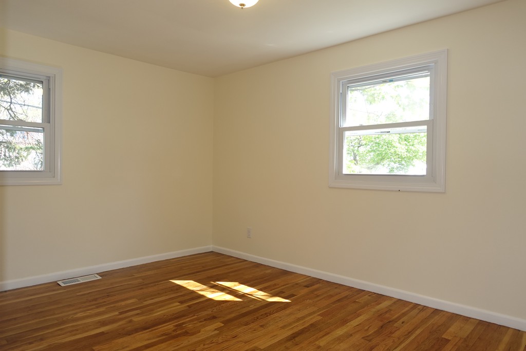 19 Dietz Road Boston, MA 02136 - Photo 7 of 15 an empty room with wooden floor and a window
