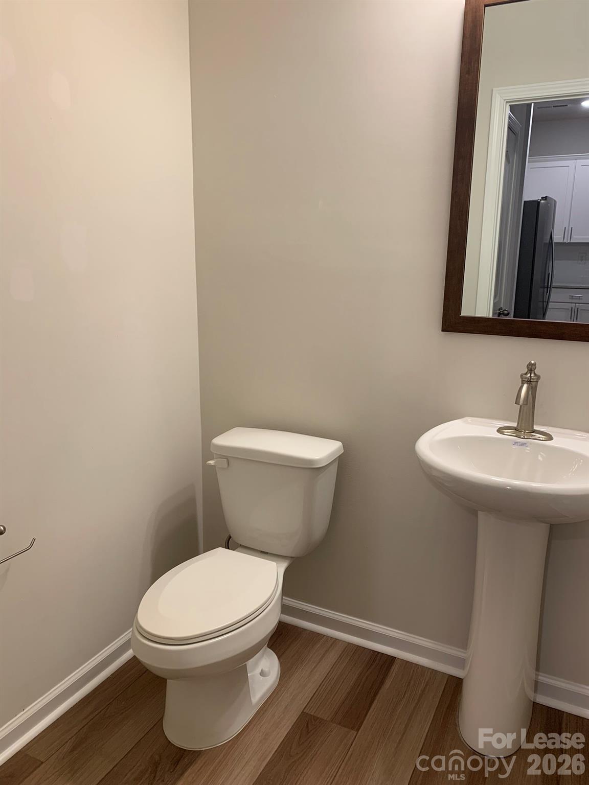 2143 Stevens Mill Road Matthews, NC 28104 - Photo 12 of 39 a bathroom with a toilet a sink and mirror