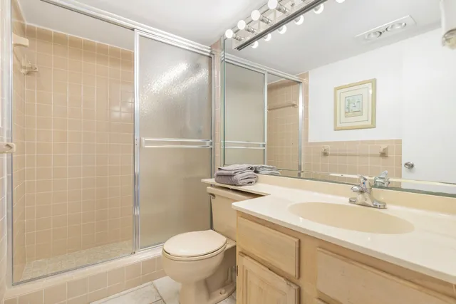 a bathroom with a sink toilet and shower