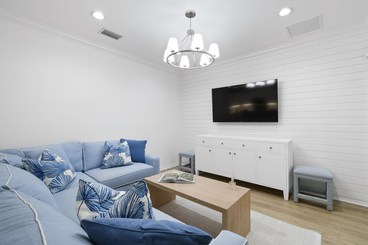 193 Porgee Rock Place Jupiter, FL 33458 - Photo 16 of 76 a living room with furniture a flat screen tv and kitchen view