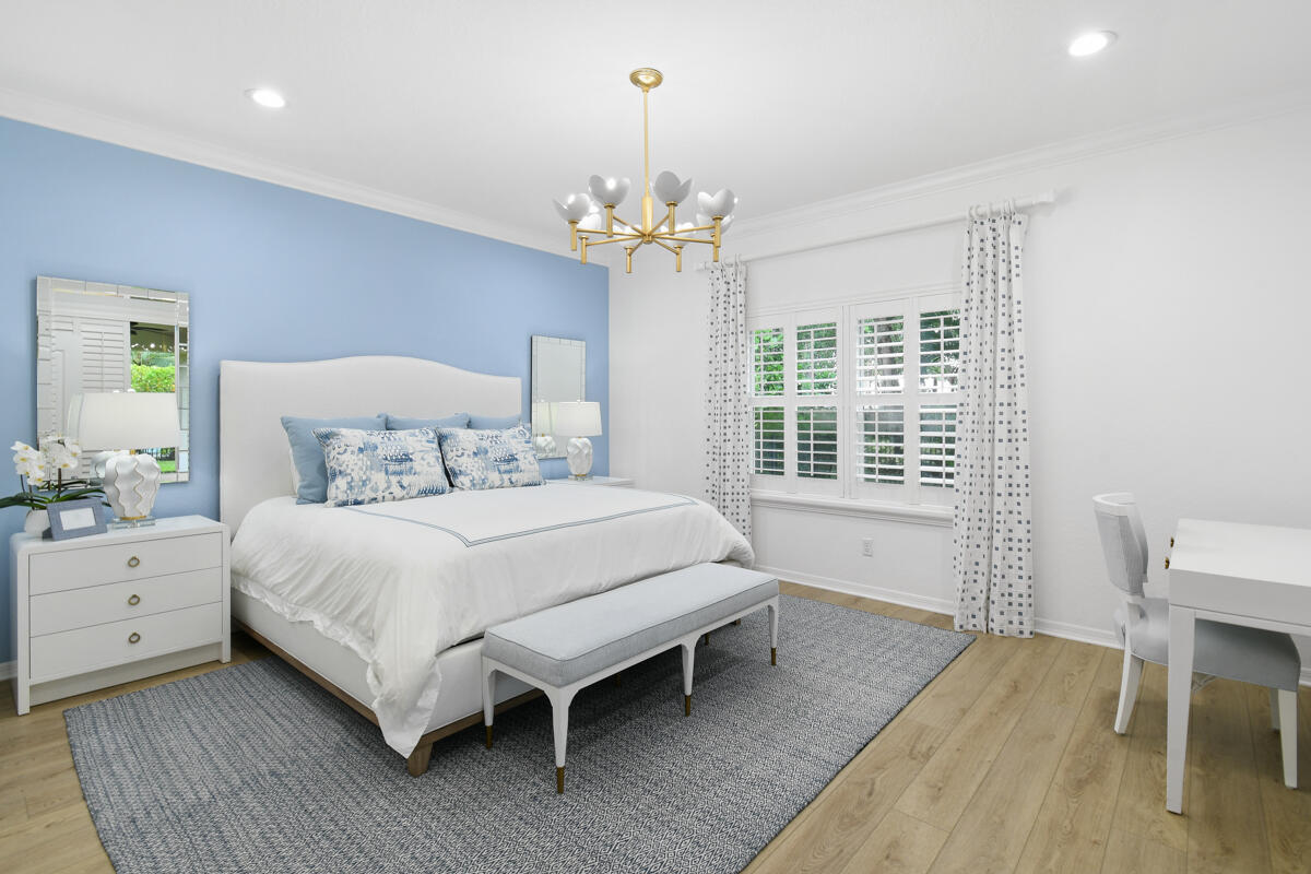 193 Porgee Rock Place Jupiter, FL 33458 - Photo 18 of 76 a bedroom with a bed chandelier and a window