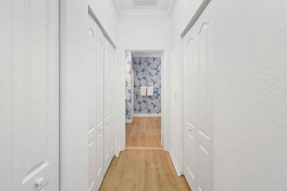 193 Porgee Rock Place Jupiter, FL 33458 - Photo 21 of 76 a view of a hallway with wooden floor and entryway