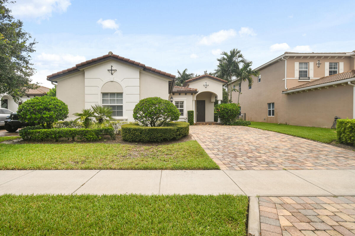 193 Porgee Rock Place Jupiter, FL 33458 - Photo 35 of 76 a front view of a house with a yard and garage