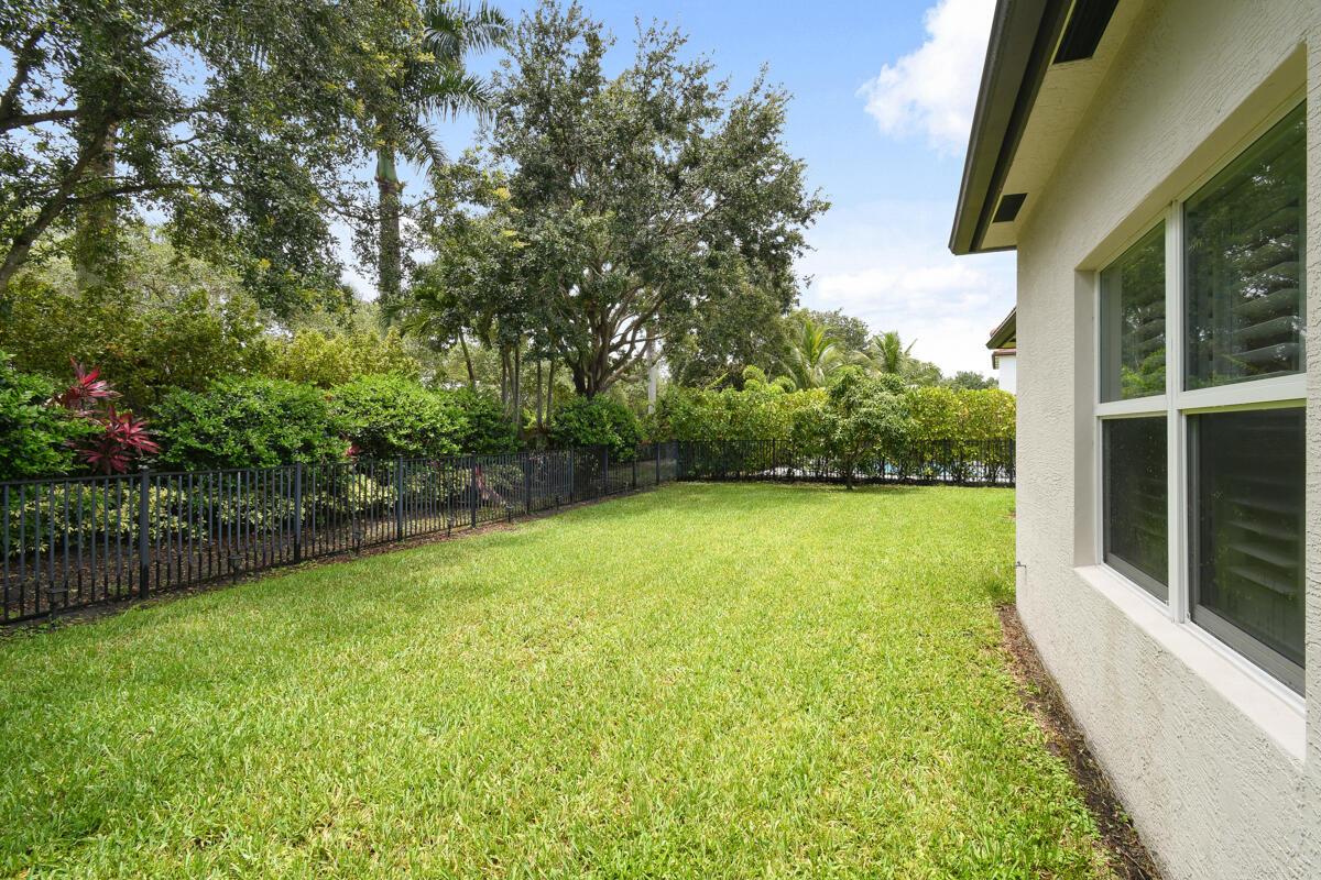 193 Porgee Rock Place Jupiter, FL 33458 - Photo 40 of 76 a view of a yard with a trees in the background