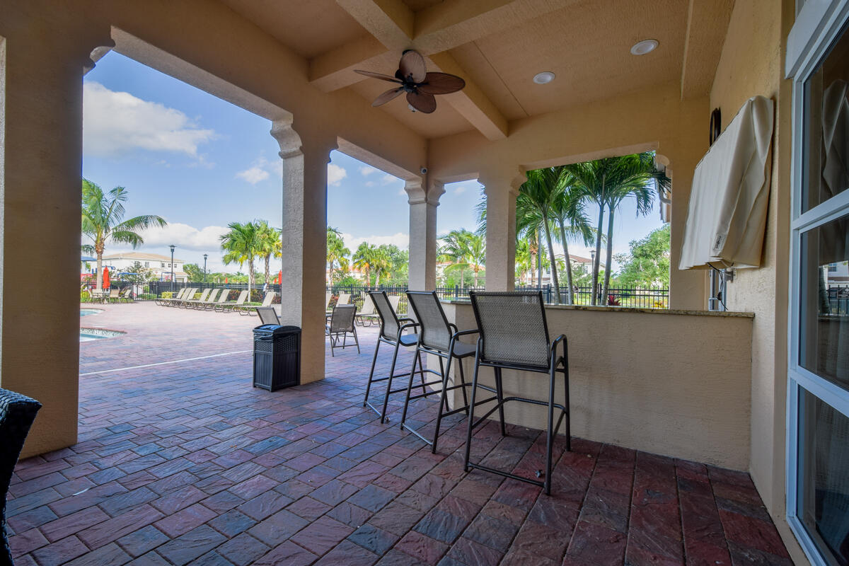 193 Porgee Rock Place Jupiter, FL 33458 - Photo 46 of 76 a dining room with furniture floor to ceiling window and potted plants