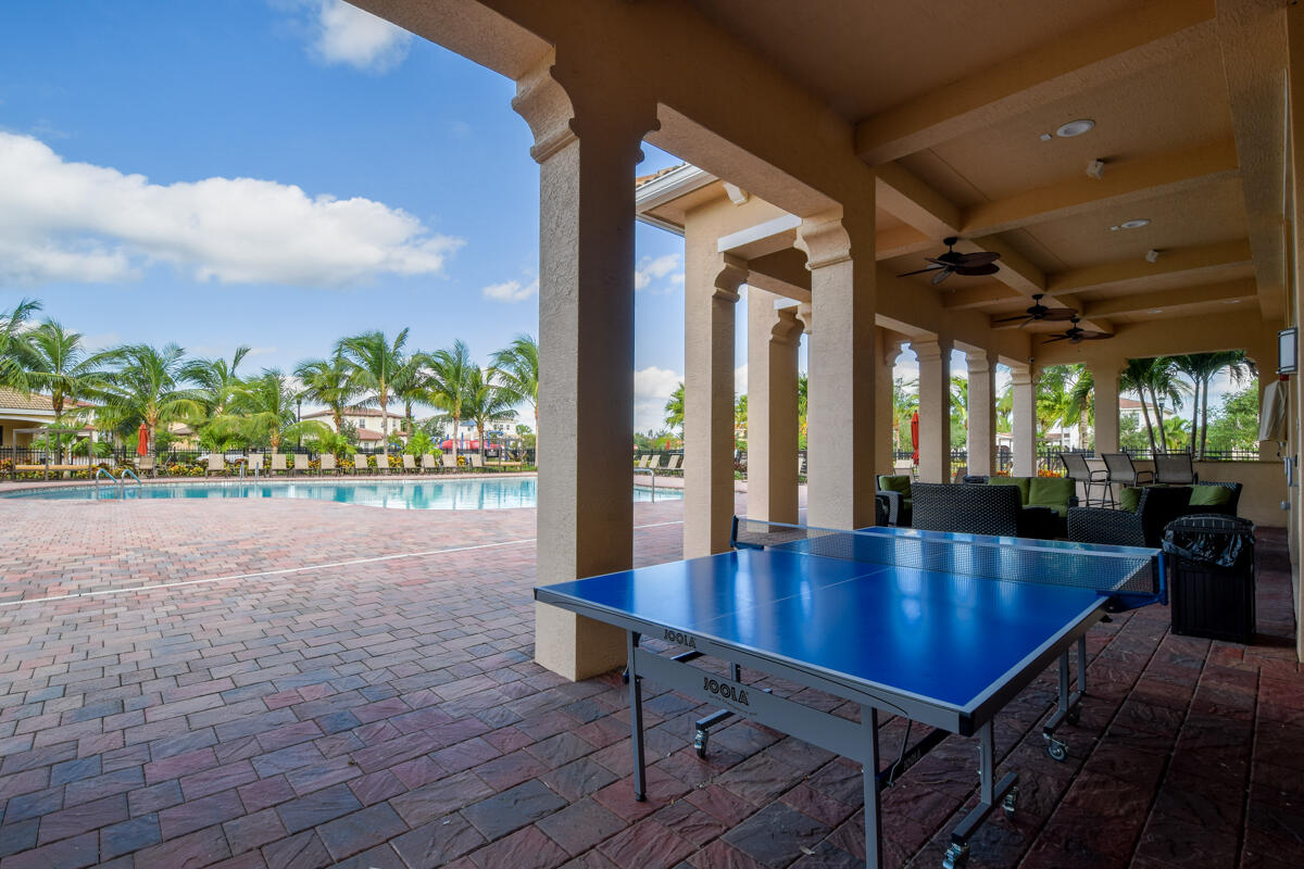 193 Porgee Rock Place Jupiter, FL 33458 - Photo 48 of 76 a dining room with wooden floor and outdoor seating