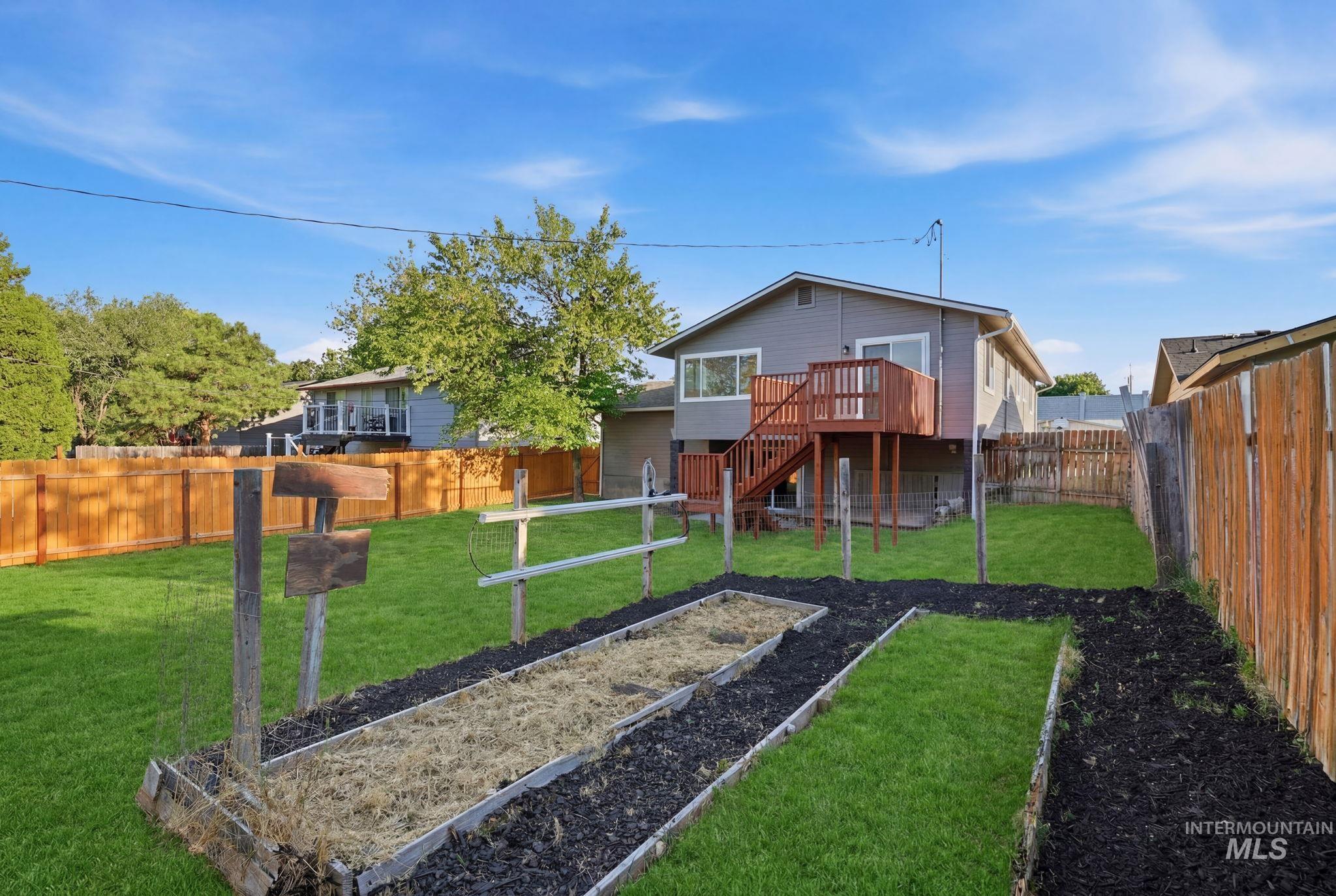 1990 Panama Street Boise, ID 83705 - Photo 48 of 50 Expansive backyard featuring a manicured lawn, established garden beds, and wood privacy fencing