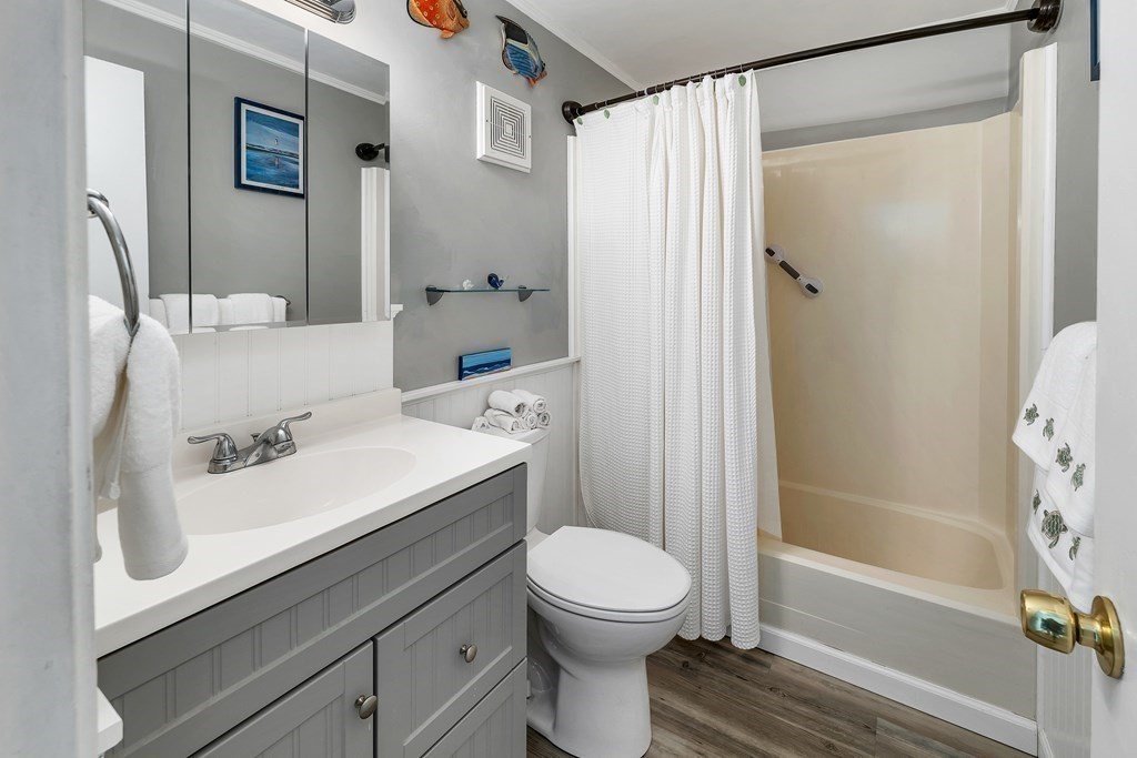 64 Esker Road, Unit 2 Hampton, NH 03842 - Photo 14 of 33 a bathroom with a sink a toilet and shower