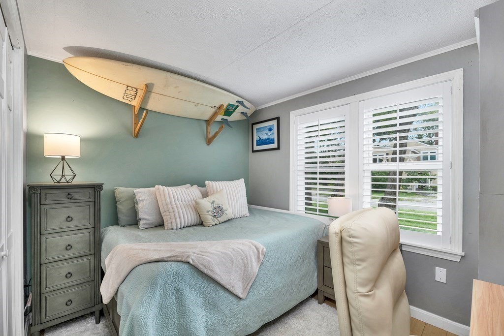 64 Esker Road, Unit 2 Hampton, NH 03842 - Photo 15 of 33 a bedroom with a bed and a window