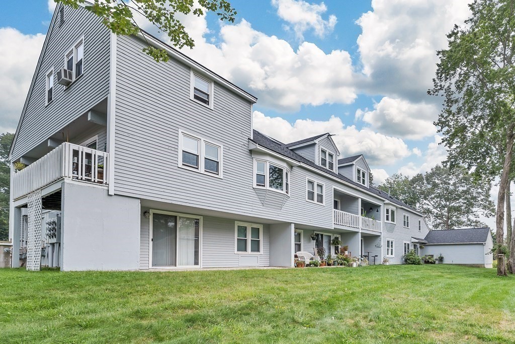 64 Esker Road, Unit 2 Hampton, NH 03842 - Photo 25 of 33 a front view of house with yard