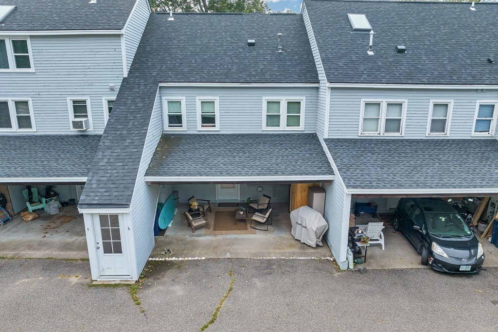 64 Esker Road, Unit 2 Hampton, NH 03842 - Photo 26 of 33 a front view of a house with barbeque grill and garage