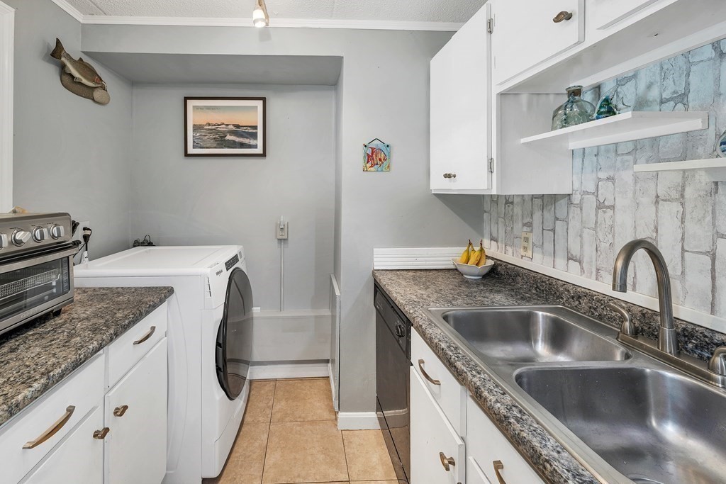64 Esker Road, Unit 2 Hampton, NH 03842 - Photo 7 of 33 a kitchen with a sink a stove and cabinets