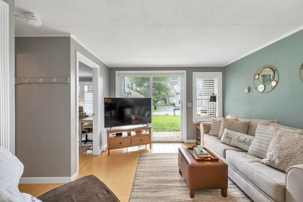 64 Esker Road, Unit 2 Hampton, NH 03842 - Photo 9 of 33 a living room with furniture and a flat screen tv