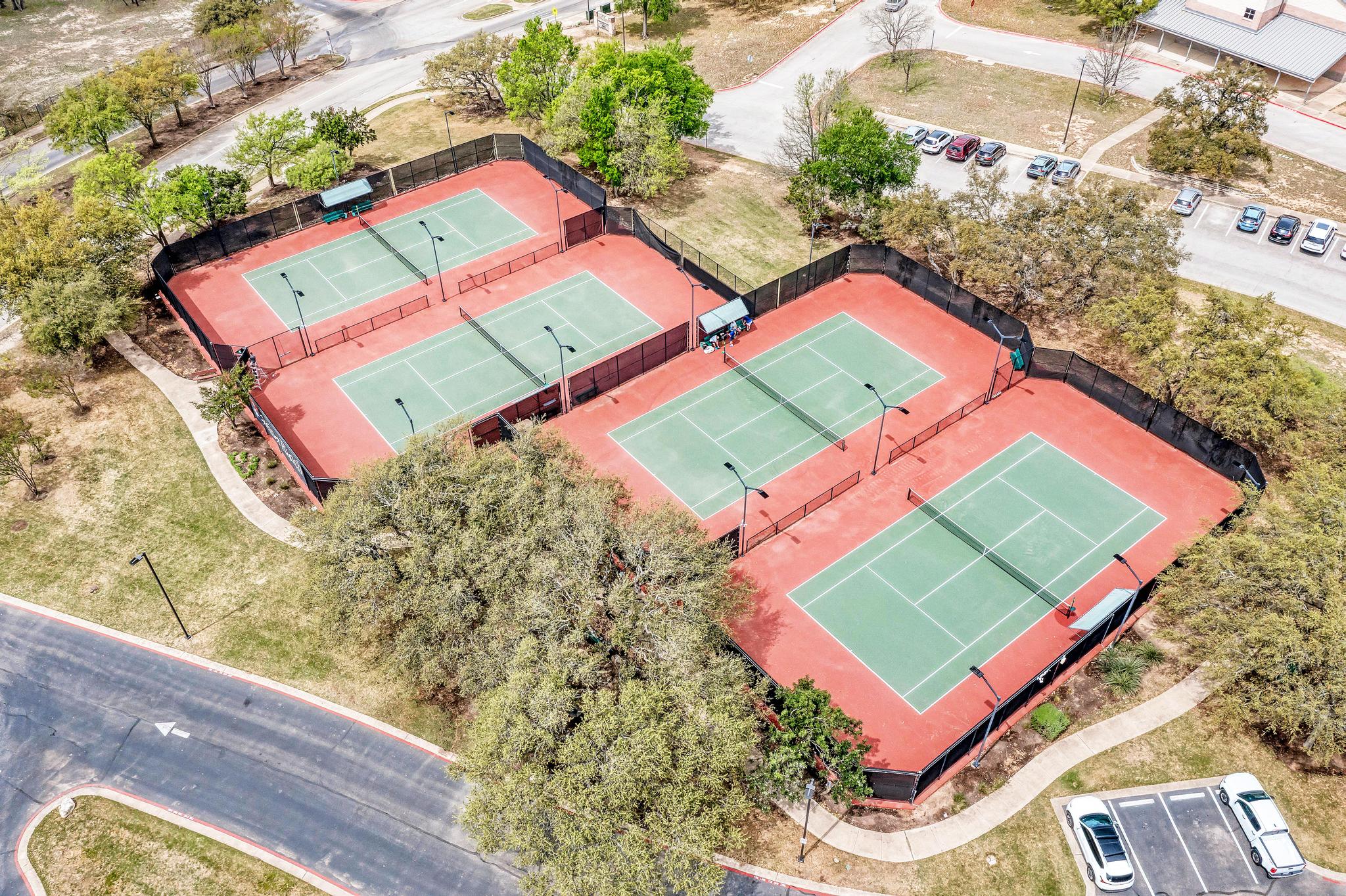 2601 North Quinlan Park Road, Unit 506 Austin, TX 78732 - Photo 38 of 39 Four vibrant tennis courts await, nestled amidst mature trees and accessible by paved paths.