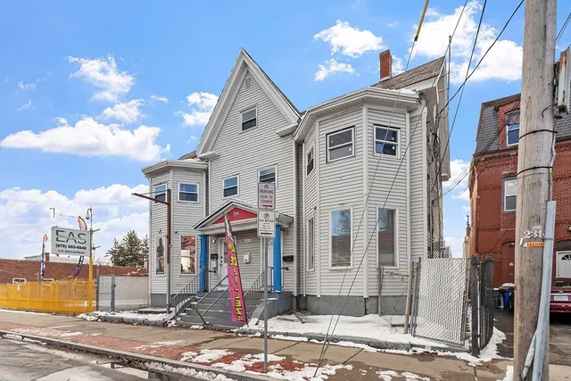a view of a white house with a yard