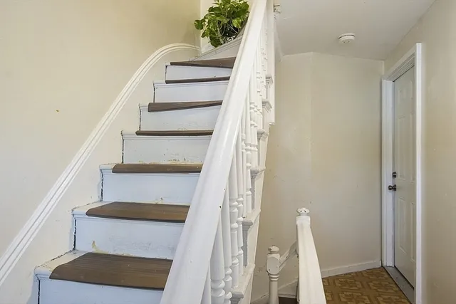 a view of entryway with wooden floor and stairs