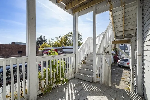 a view of a balcony with wooden floor