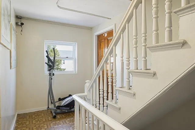 a view of entryway and hall with wooden floor