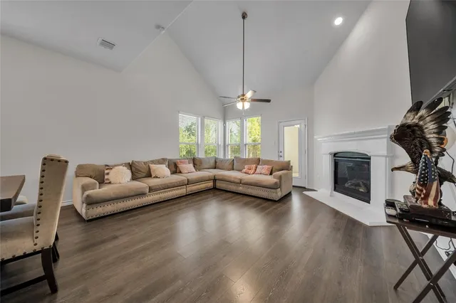 a living room with fireplace furniture and a wooden floor