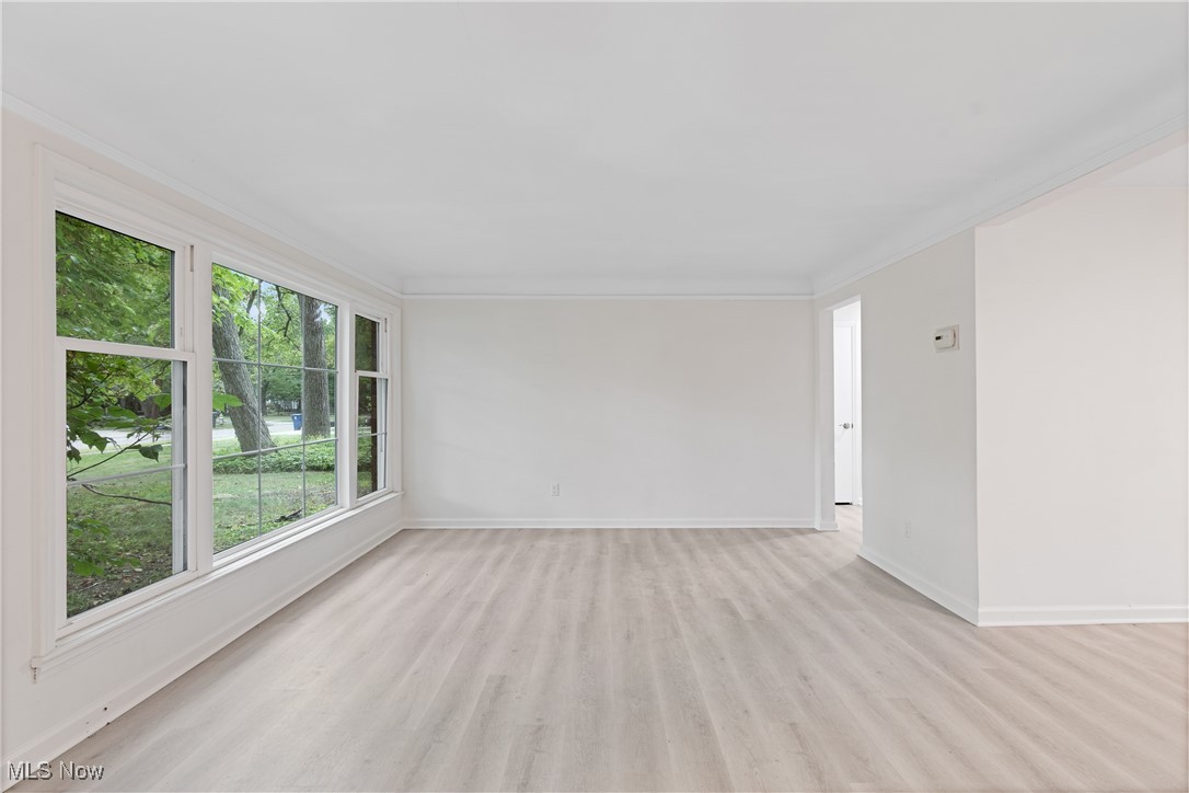1057 Renfield Road Cleveland Heights, OH 44121 - Photo 3 of 30 Empty room featuring light hardwood / wood-style floors and crown molding