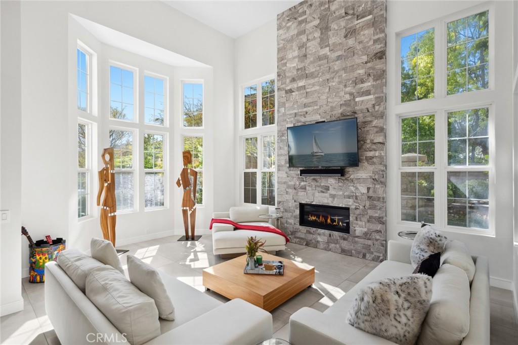 3 Bridgeport Road Newport Coast, CA 92657 - Photo 5 of 25 a living room with furniture a fireplace and a flat screen tv