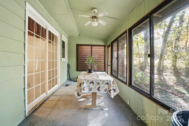 a bedroom with furniture and a large window