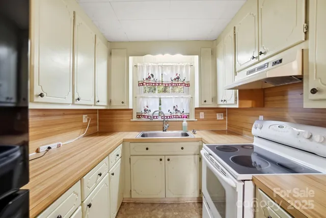 a kitchen with a sink stove and cabinets