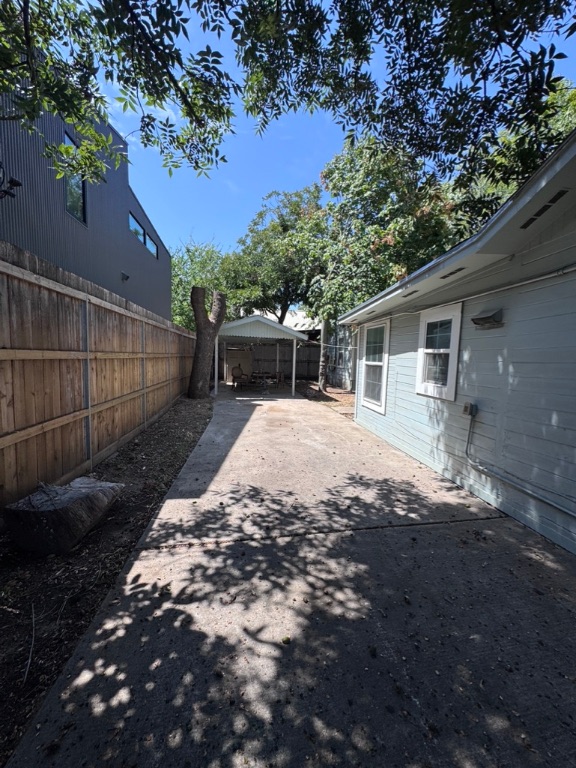 2209 East 5th Street Austin, TX 78702 - Photo 16 of 17 a view of a backyard with wooden fence and large trees