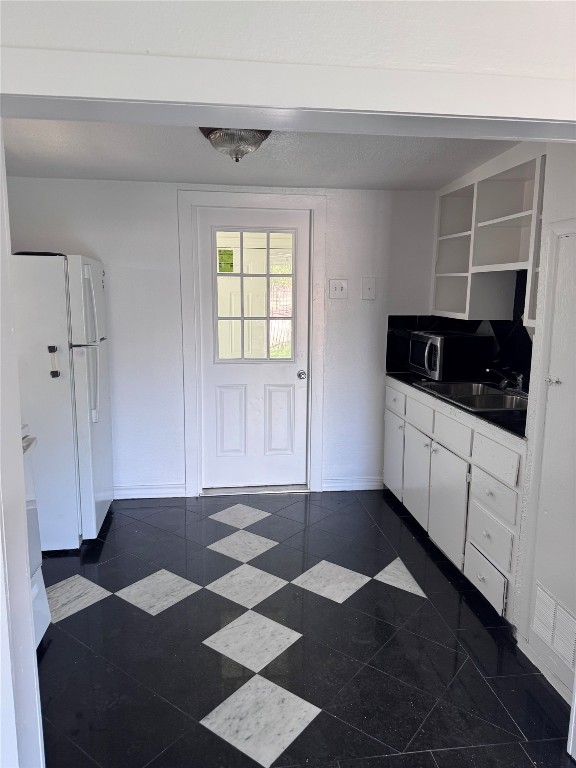 2209 East 5th Street Austin, TX 78702 - Photo 5 of 17 a view of a kitchen with a black and white checkered floor