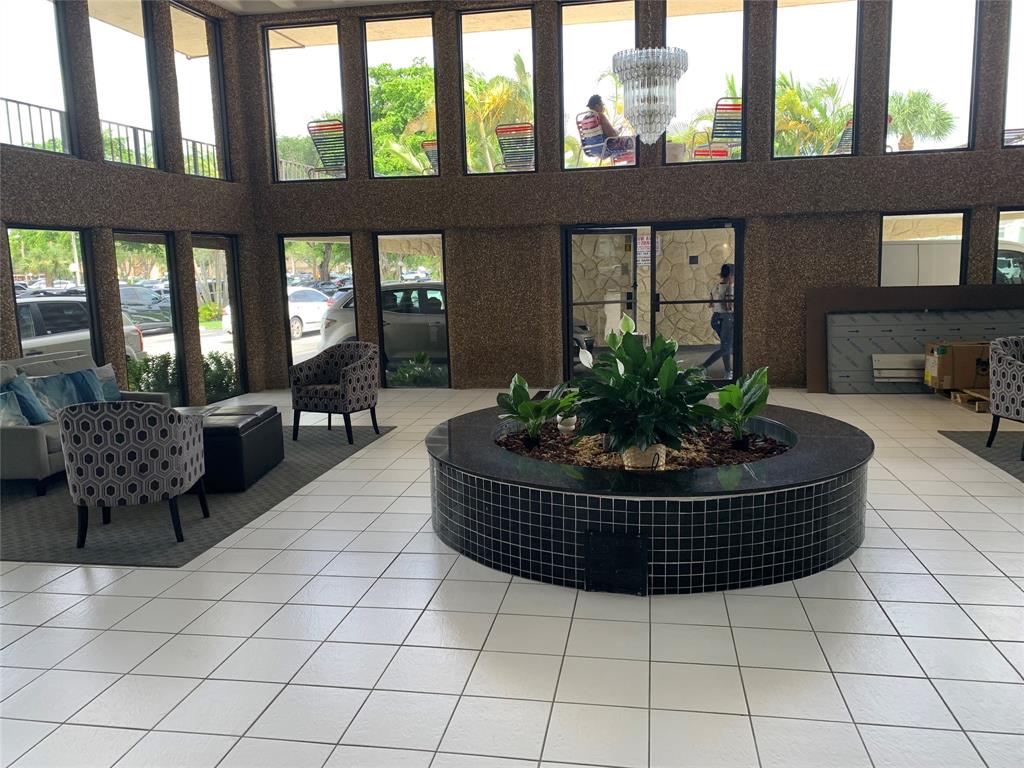 9355 Southwest 8th Street, Unit 321 Boca Raton, FL 33428 - Photo 13 of 15 a living room with a large window and a table